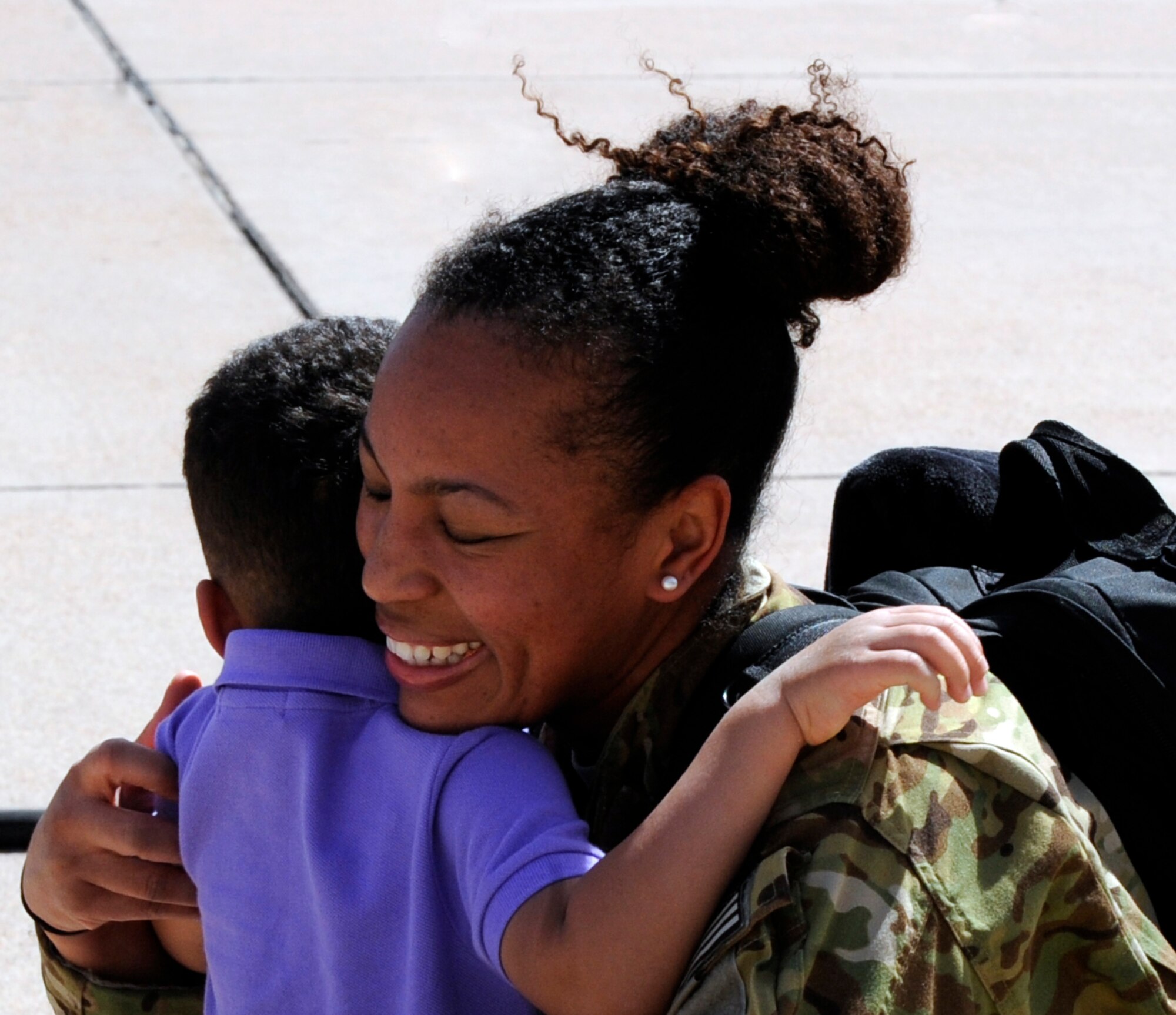 U.S. Air Force Staff Sgt. Aquarius Benoit, 39th Airlift Squadron, holds her son March 18, 2014, at Dyess Air Force Base, Texas. While deployed, Airmen supported theater commander’s requirements with combat-delivery capability through tactical airdrop operations as well as humanitarian efforts and aeromedical evacuation. (U.S. Air Force photo by Airman 1st Class Alexander Guerrero/Released)