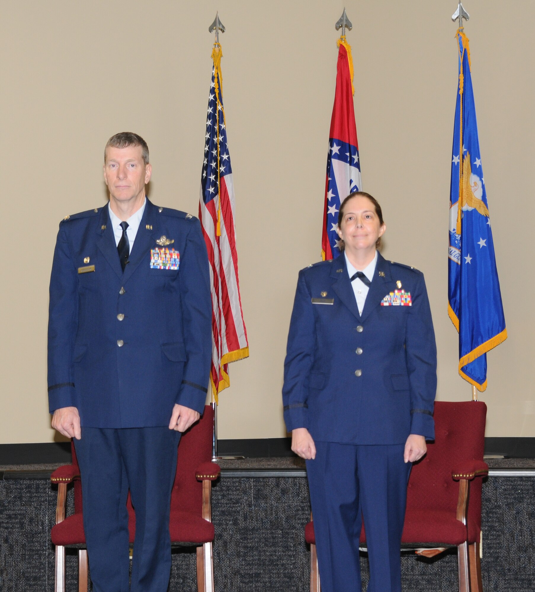 Col. Mark Anderson, 188th Fighter Wing commander, left, stands at attention with Col. Misty Zelk, 188th Medical Group commander, during a ceremony in which Zelk was promoted to colonel at Ebbing Air National Guard Base, Ark., March 2, 2014. Zelk is first female in the 188th Fighter Wing's 60-year history to be promoted to 0-6. (U.S. Air National Guard photo by Tech. Sgt. Josh Lewis/released) 