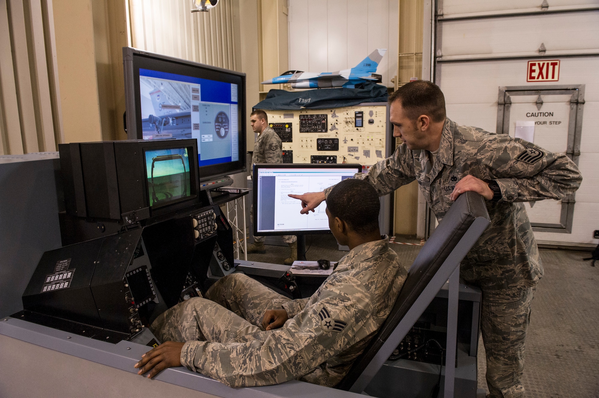Tech. Sgt. Dustin Marr, 372nd Training Squadron Detachment 25 weapons instructor, uses the TFE-55 combined avionics and armament trainer system to instruct Senior Airman Kamryn Dungy, 354th Maintenance Squadron weapons loader, on fault detection procedures of the F-16 Fighting Falcon armament system March 7, 2014, Eielson Air Force Base, Alaska. Advanced classes are Pacific Air Forces mandated and must be attended for upgrade training. (U.S. Air Force photo by Senior Airman Joshua Turner/Released)