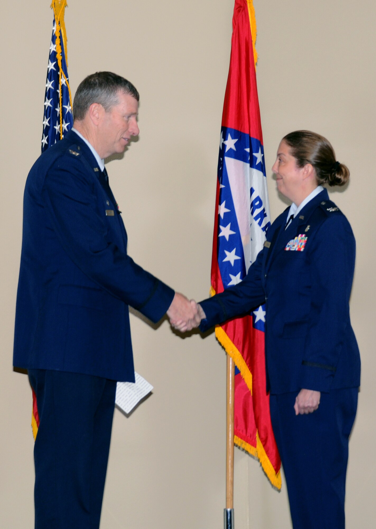 Col. Mark Anderson, 188th Fighter Wing commander, left, shakes hands with Col. Misty Zelk, 188th Medical Group commander, during a ceremony in which Zelk was promoted to colonel at Ebbing Air National Guard Base, Ark., March 2, 2014. Zelk is first female in the 188th Fighter Wing's 60-year history to be promoted to 0-6. (U.S. Air National Guard photo by Tech. Sgt. Josh Lewis/released) 