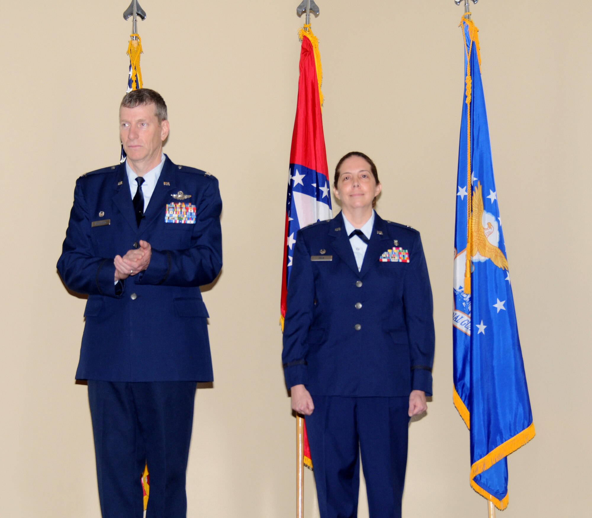 Col. Mark Anderson, 188th Fighter Wing commander, left, applauds during the promotion ceremony for Col. Misty Zelk, 188th Medical Group commander, at Ebbing Air National Guard Base, Ark., March 2, 2014. Zelk is the first female in the 188th Fighter Wing's 60-year history to be promoted to 0-6. (U.S. Air National Guard photo by Tech. Sgt. Josh Lewis/released) 