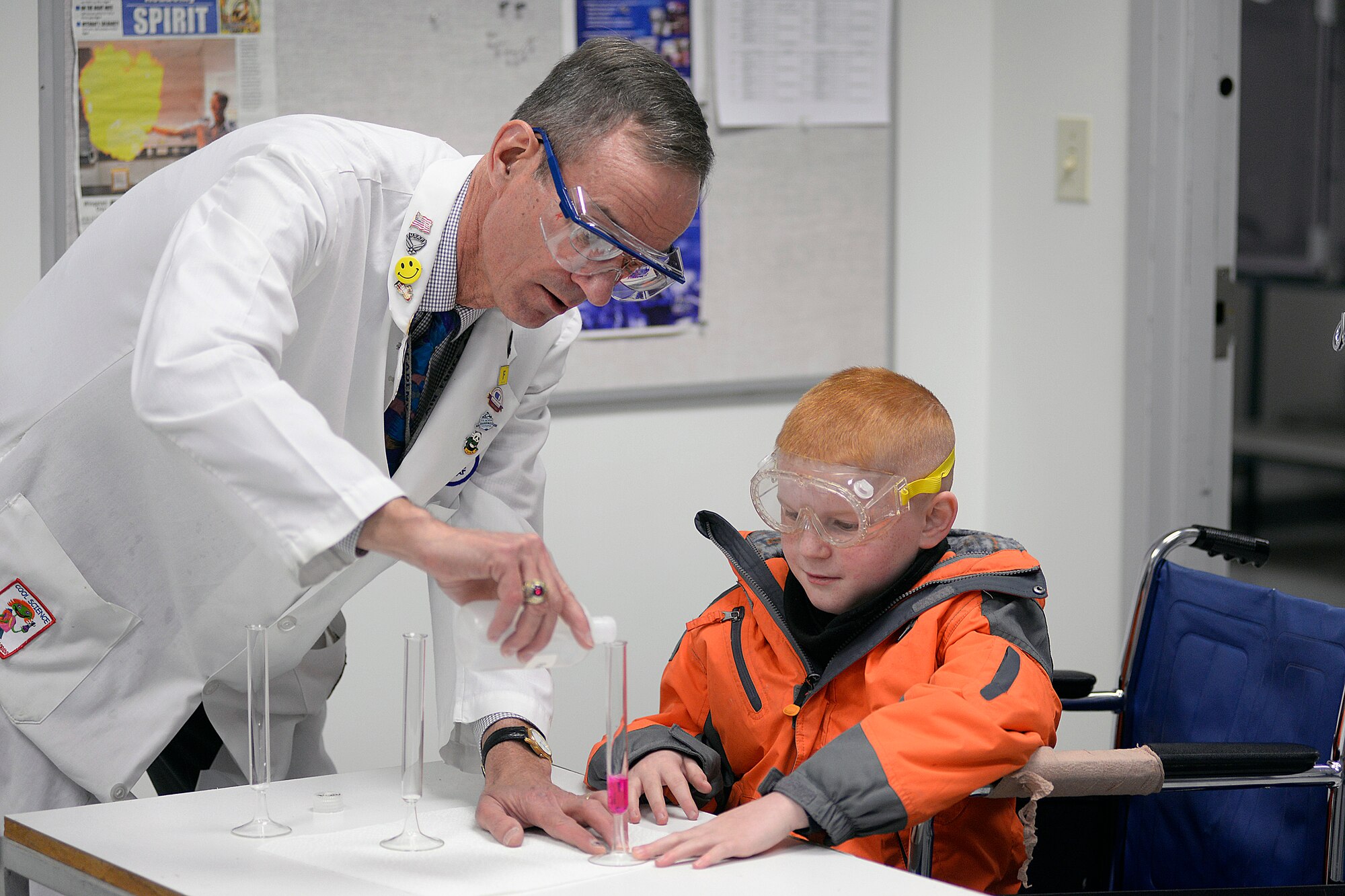 Dr. Ron Furstenau, an Academy chemistry professor, shows Dylan a chemistry magic trick during Dylan's tour of the Academy Wednesday.