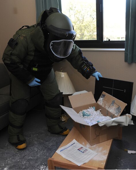 Staff Sgt. Timothy Ostberg, 2nd Civil Engineer Squadron Explosive Ordnance Disposal technician, X-rays a simulated risin dispersal device inside a dorm room on Barksdale Air Force Base, La., March 13, 2014.  During the exercise, Ostberg used the x-ray to check if there were any other detonation devices inside the box. (U.S. Air Force photo/Senior Airman Joseph A. Pagán Jr.)