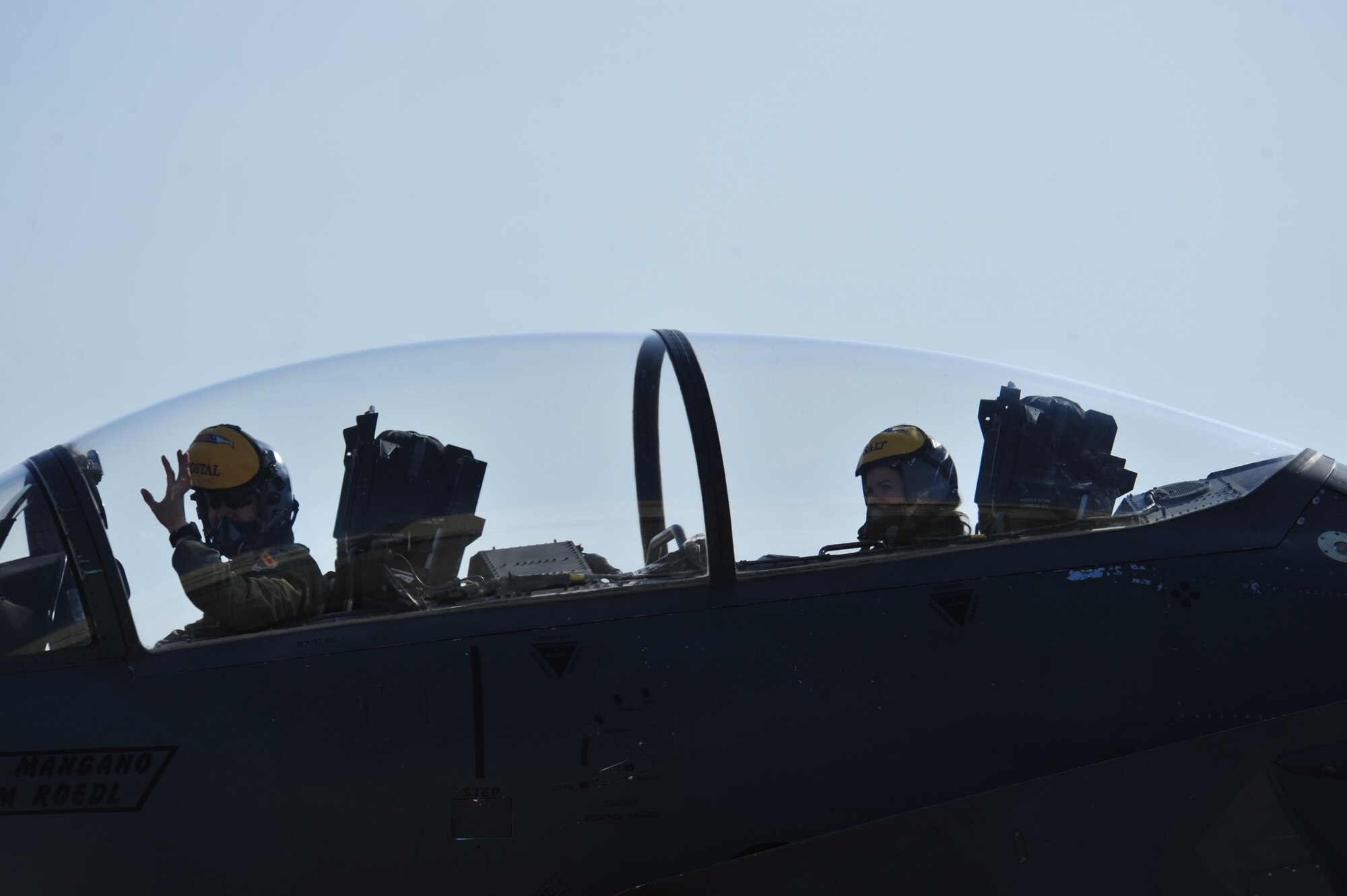 An F-15E Strike Eagle pilot and weapons system officer, from the 336th Fighter Squadron, wave to families waiting on the flight line, March 15, 2014, at Seymour Johnson Air Force Base, N.C. The 336th FS Airmen were returning from Nellis Air Force Base, Nev., where they were the host wing for Red Flag 14-2. (U.S. Air Force photo/Airman 1st Class Shawna L. Keyes)