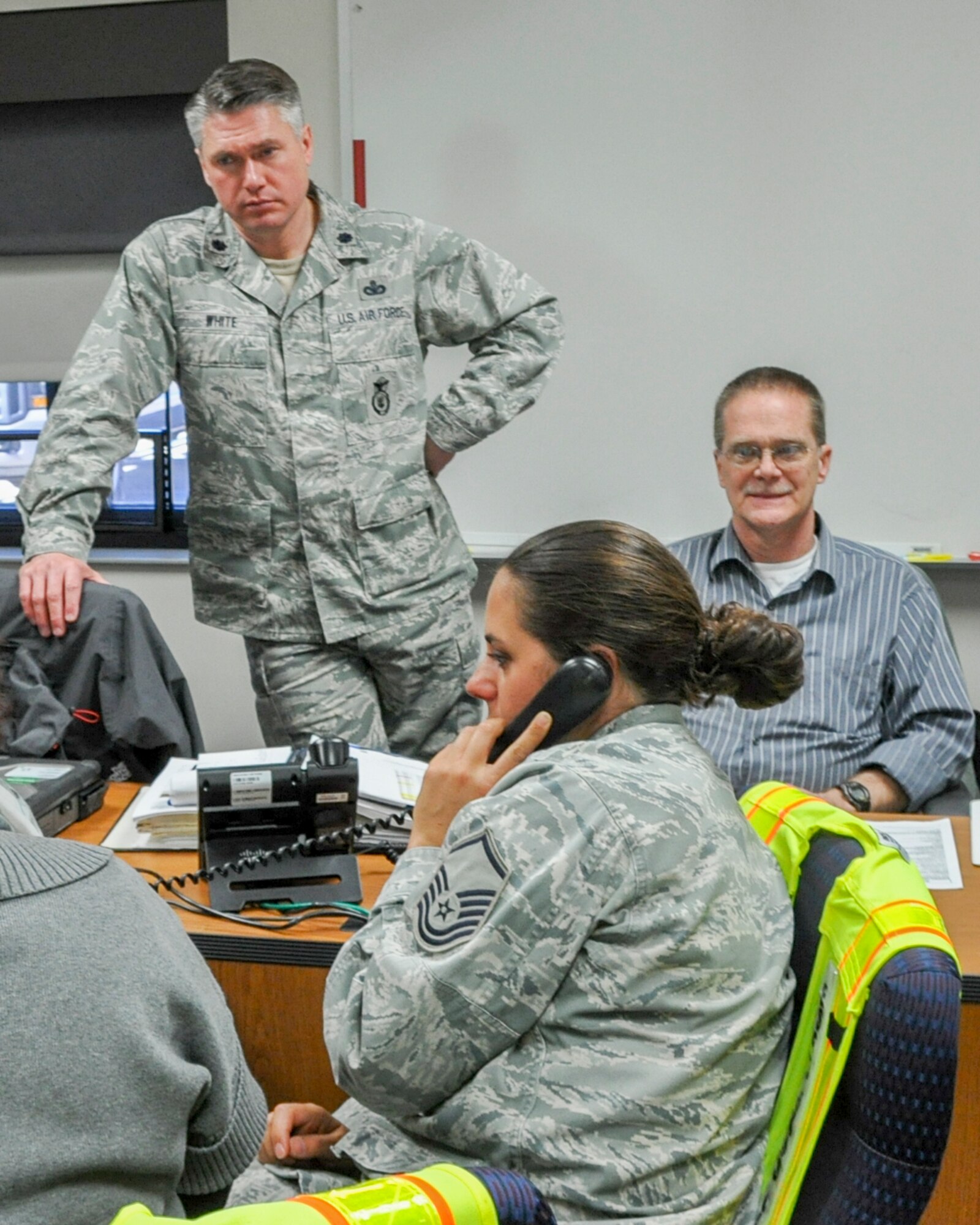 U.S. Air Force Reserve Lt. Colonel Thomas White, 910th Security Forces Squadron commander and interim 910th Mission Support Group Commander, awaits an accountability update from staff members in the Emergency Operations Center (EOC) during an active shooter exercise here, March 18, 2014. The purpose of the base-wide exercise was to identify and correct response weaknesses, ensuring safety and security of personnel and property. (U.S. Air Force photo/Major Brent Davis)