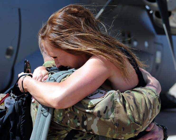 U.S. Air Force Capt. David Ferrara, 39th Airlift Squadron, hugs his wife 1st Lt. Nicole Ferrara, 7th Bomb Wing, during a welcome home ceremony March 18, 2014, at Dyess Air Force Base, Texas. In September 2013, more than 170 Airmen deployed for six months in support of combat operations in Afghanistan. (U.S. Air Force Photo by Airman 1st Class Kedesha Pennant/Released)

