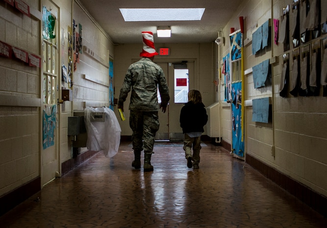 Airman 1st Class Max Wanzy, 628th Contracting Squadron specialist, walks down the hall with a student from St. Andrews Elementary School March 7, 2014. More than 30 Airmen from Joint Base Charleston attended the event having breakfast with the children, answering question about the Air Force and reading the children’s favorite Dr. Seuss book. (U.S. Air Force photo/ Senior Airman Dennis Sloan)