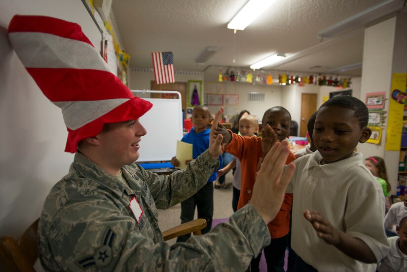 Airman 1st Class Max Wanzy, 628th Contracting Squadron specialist, reads a Dr. Seuss book to children at St. Andrews Elementary School March 7, 2014. More than 30 Airmen from JB Charleston attended the annual reading event, ate breakfast with the children, answered questions about the Air Force and then read the children’s favorite Dr. Seuss book.  (U.S. Air Force photo/ Senior Airman Dennis Sloan)