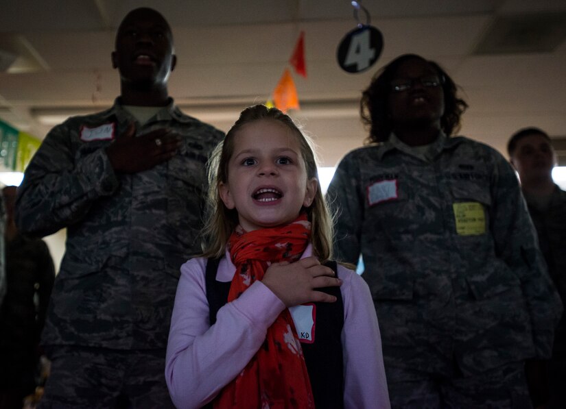 Piper Soliyan, a St. Andrews Elementary School kindergarten student, says the Pledge of Allegiance with Airmen from Joint Base Charleston, S.C., before Airmen read to the children March 7, 2014. More than 30 Airmen from JB Charleston attended the annual reading event, ate breakfast with the children, answered questions about the Air Force and then read the children’s favorite Dr. Seuss book. (U.S. Air Force photo/ Senior Airman Dennis Sloan)