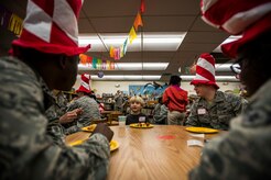 Hoyt Darden, a St. Andrews Elementary School kindergarten student, eats breakfast with a group of Airmen from Joint Base Charleston, S.C., before the Airmen read their favorite Dr. Seuss books to the students March 7, 2014. More than 30 Airmen from JB Charleston attended the event, ate breakfast with the children and answered questions about the Air Force. (U.S. Air Force photo/ Senior Airman Dennis Sloan)