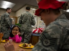 Natalie Brown, a St. Andrews Elementary School first grader, eats breakfast with Airmen from Joint Base Charleston, S.C., before the Airmen read their favorite Dr. Seuss books to the students March 7, 2014. More than 30 Airmen from JB Charleston attended the annual reading event, ate breakfast with the children, answered questions about the Air Force and then read the children’s favorite Dr. Seuss book. (U.S. Air Force photo/ Senior Airman Dennis Sloan)