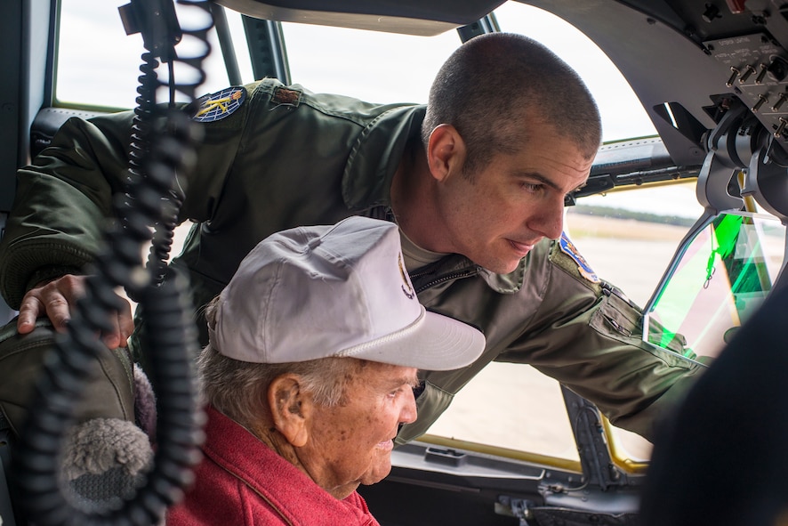 Retired U.S. Air Force Lt. Col. Jack Lenox, bottom, receives a demonstration on the modern cockpit systems aboard the HC-130J Combat King II from Maj. Eric Lipp, 71st Rescue Squadron HC-130J evaluation pilot at Moody Air Force Base, Ga., March 7, 2014. Lenox flew 12 different aircraft and is an Ace with four confirmed victories over German fighters. (U.S. Air Force photo by Airman 1st Class Ryan Callaghan/Released)