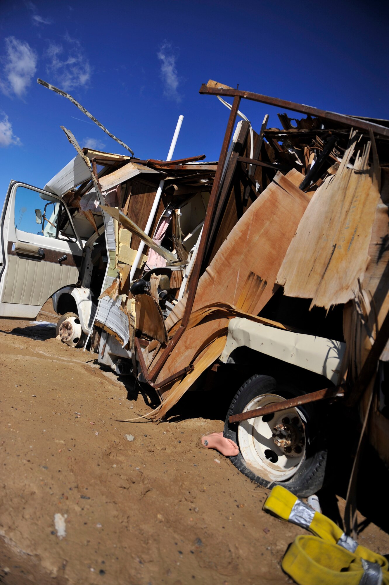 A plastic foot sticks out from underneath a demolished recreational vehicle at the Colorado National Guard Chemical, Biological, Radiological, Nuclear and High-Yield Explosive Enhanced Response Force Package training site March 8, 2014, in Lakewood, Colo. The CERFP team spends one weekend every three months training in a emergency exercise to refine their skills in search and rescue, decontamination and medical procedures. (U.S Air Force photo by Airman 1st Class Samantha Saulsbury/Released)