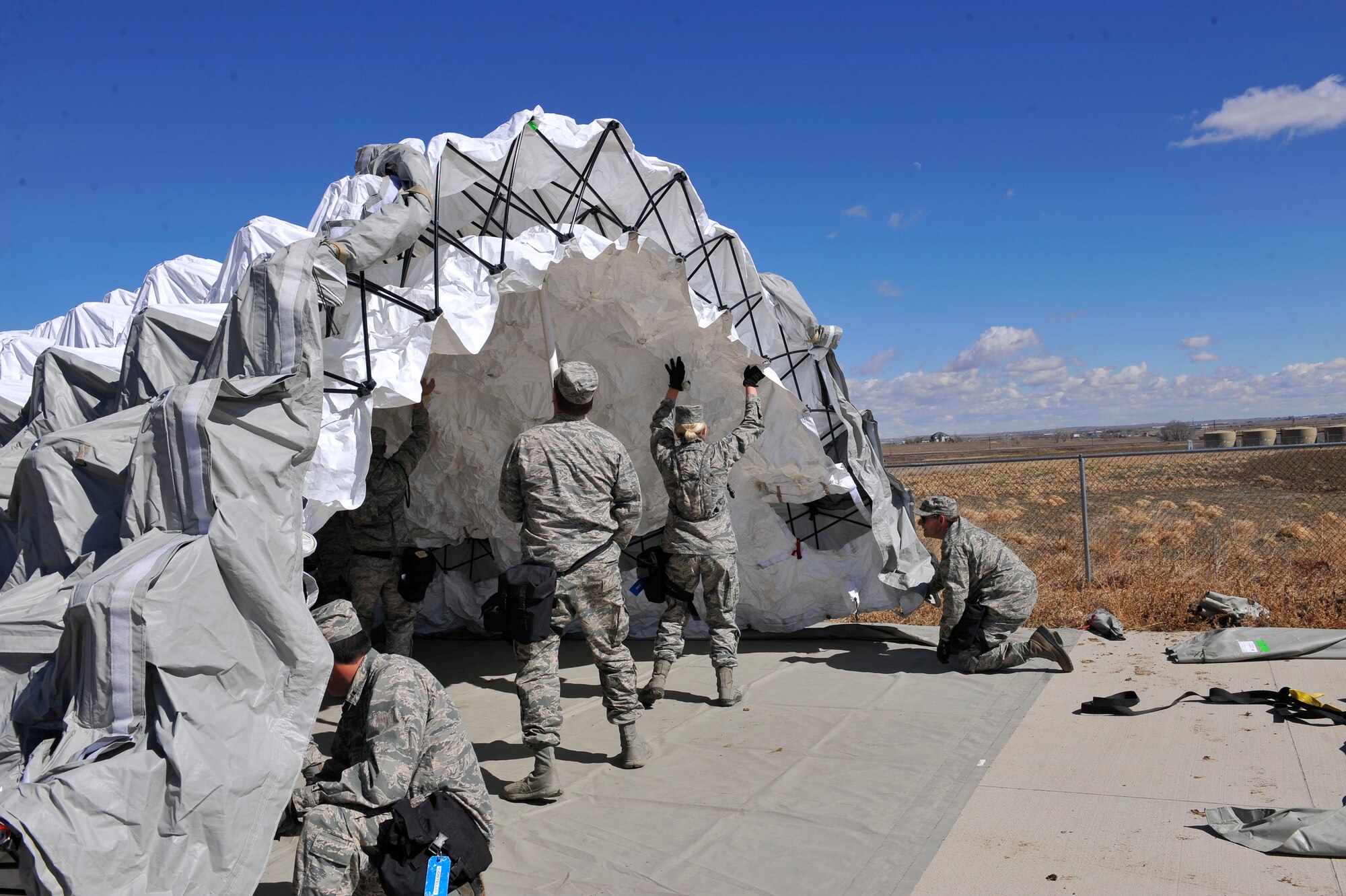 Colorado Air National Guard 140th Medical Group members assemble a medical tent during Colorado National Guard Chemical, Biological, Radiological, Nuclear and High-Yield Explosive Enhanced Response Force Package exercise March 8, 2014, in Lakewood, Colo. The CERFP team spends one weekend every three months training in an emergency exercise to refine their skills in search and rescue, decontamination and medical procedures. (U.S Air Force photo by Airman 1st Class Samantha Saulsbury/Released)