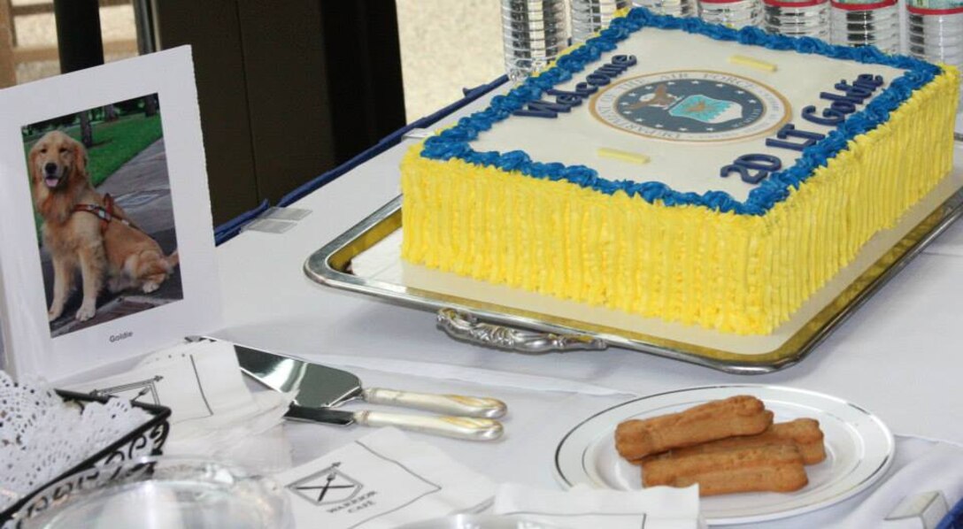 A cake with second lieutenant bars and a plate of doggie treats celebrate Goldie’s commission into the Air Force. (Photo by Bernard S. Little)