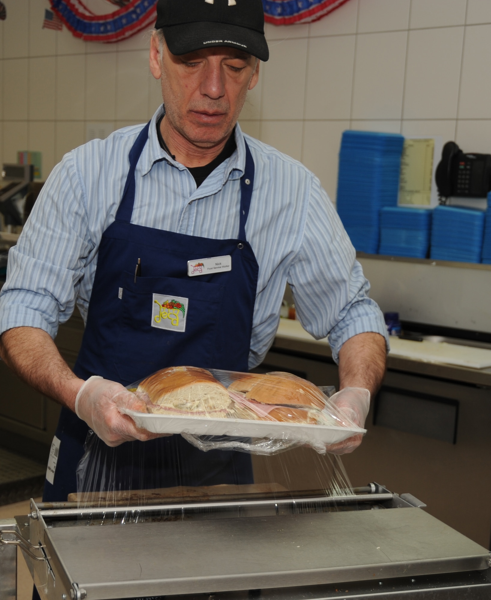 Nick Constance, a food service worker, wraps a sandwich at the commissary deli at Spangdahlem Air Base, Germany, March 18, 2014. Food service workers prepare salads, rotisserie chicken and meat sliced-to-order for customers in addition to making sandwiches. (U.S. Air Force photo by Airman 1st Class Dylan Nuckolls/Released) 
