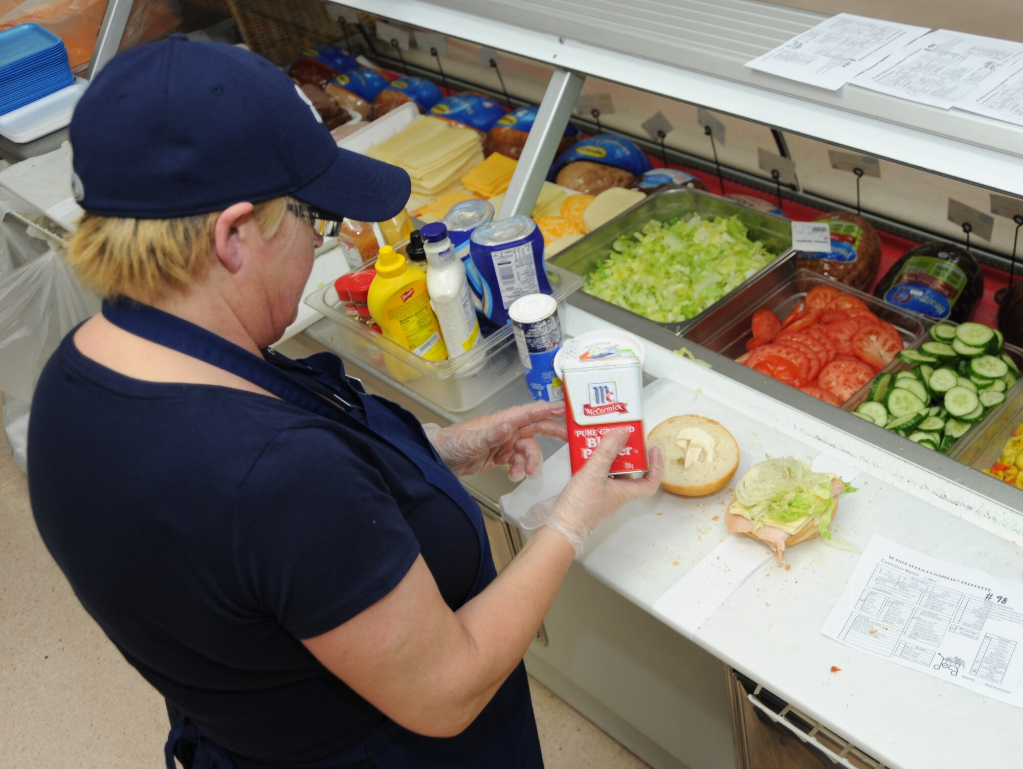 Steffi Anton, a food service worker, prepares a sandwich at the commissary deli at Spangdahlem Air Base, Germany, March 18, 2014. Food service workers make on average between 250 to 350 sandwiches for customers each day. (U.S. Air Force photo by Airman 1st Class Dylan Nuckolls/Released) 