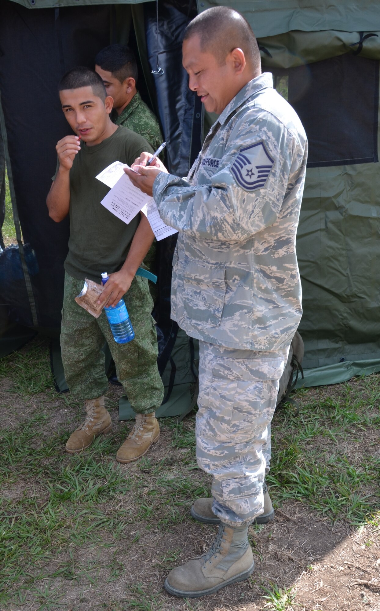 Master Sgt. Enrique Naranjo, New Horizons logistics superintendent, prepares a MRE hand receipt for the Belize Defence Force soldiers securing New Horizons equipment at the Belmopan Hospital construction site, March 11. During the past 20 years, U.S. Southern Command has worked side-by-side with the Belize Defence Force as well as the Ministries of Health and Education to conduct combined exercises to strengthen each participant's response to humanitarian relief scenarios. (USAF photo by Master Sgt. Kelly Ogden/Released)