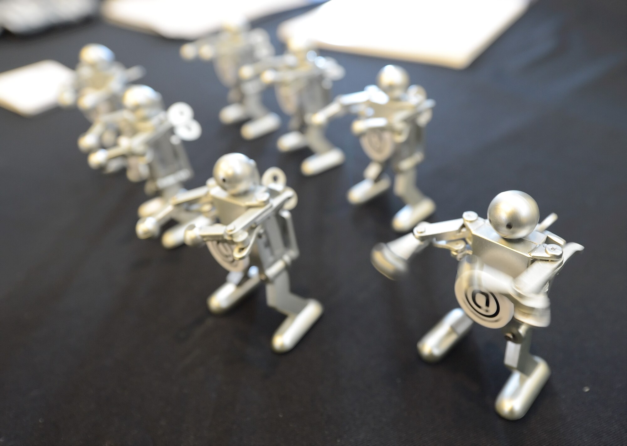 Small, dancing robots stand on a tradeshow table to attract attention of potential customers during the 2014 Dover Air Force Base Technology Exposition at The Landings Club, March 18, 2014, at Dover Air Force Base, Del. The robots were given to interested parties. (U.S. Air Force photo/Greg L. Davis)