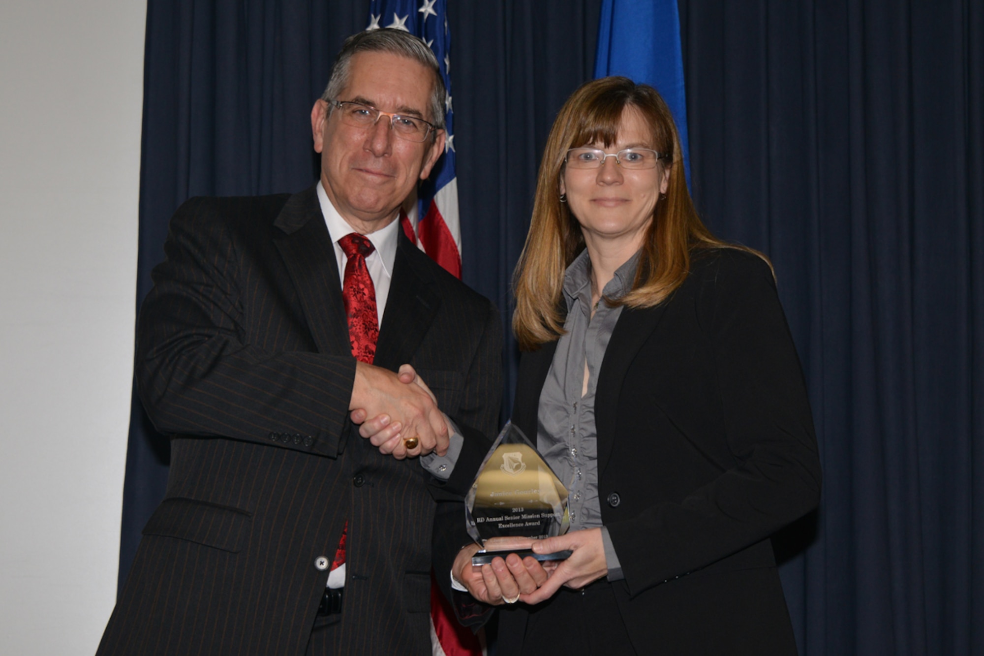 Dr. David Hardy, director of the AFRL Directed Energy Directorate, presents the senior mission support excellence award to Janice Gourley at the AFRL Phillips Research Site 2013 Annual Awards ceremony. (Photo by Todd Berenger)