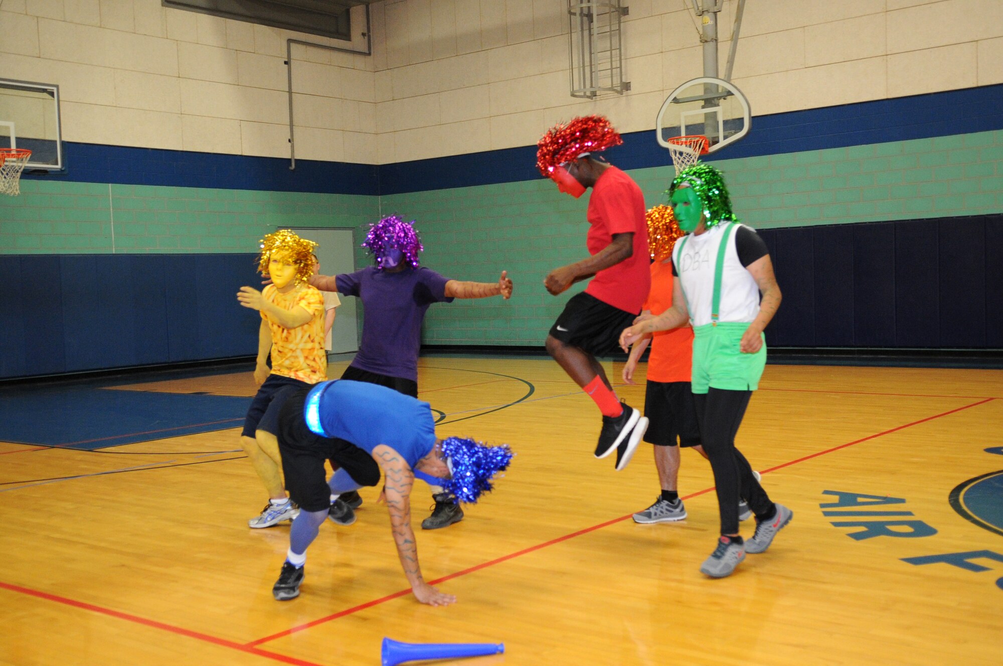 GOODFELLOW AIR FORCE BASE, Texas -- Base members do a victory dance after winning best costume during the Sexual Assault Prevention and Response dodgeball tournament here March 1. Participants in the tournament were encouraged to wear costumes. (U.S. Air Force photo/ Staff Sgt. Laura R. McFarlane)