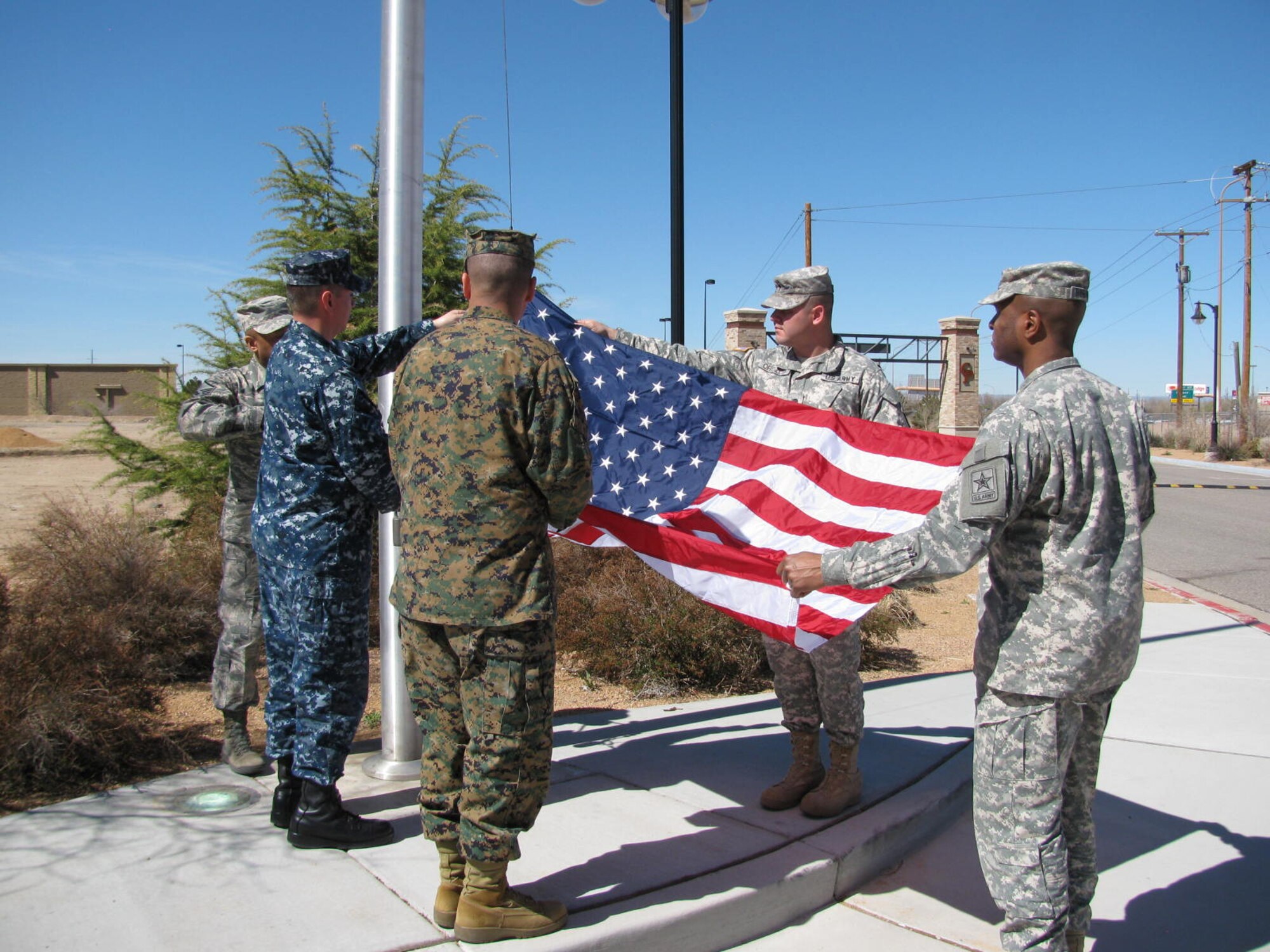 Albuquerque Military Entrance and Processing Station staff members and interservice recruiting liaison partners hold a joint service flag ceremony in honor of Chief Navy Diver Frank Durkin, who retires from active duty service in November after 23 years of service. Durkin grew up in Jemez Springs, N.M. (Courtesy photo)  