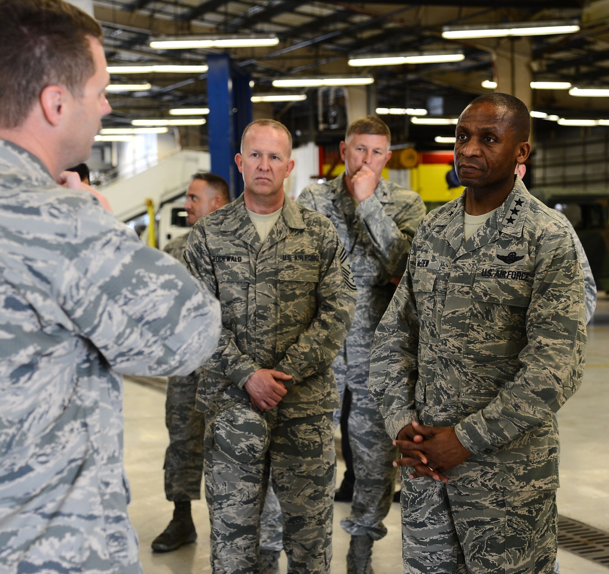 Lt. Gen. Darren McDew, 18th Air Force commander, and Chief Master Sgt. Robert Rodewald, 18th Air Force command chief, receive a brief from Lt. Col. Collin Gilbert, 6th Logistics Readiness Squadron commander, at MacDill Air Force Base, Fla., March 12, 2014. The brief went over renovations vehicle maintenance has made to improve their work environment. (U.S. Air Force photo by Airman 1st Class Tori Schultz/Released)