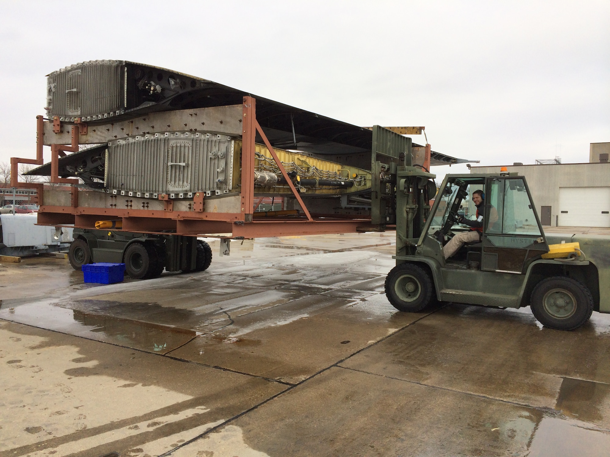 Matt Russell, 934th Logistics Readiness Squadron, loads the wings from "Frankenherc" onto a truck bound for Robins AFB, Ga.  The outer wings will be used on a Coast Guard C-130. (Air Force Photo/Mike Dressen)
