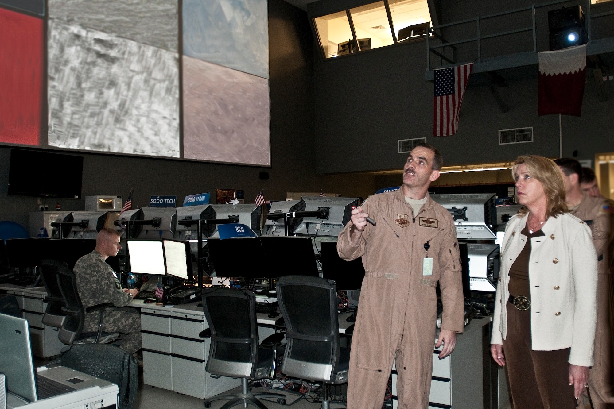 Col. Mike Schnabel, combat operations division director, gives Secretary of the Air Force Deborah Lee James a tour of the Combined Air and Space Operations Center (CAOC) at Al Udeid Air Base, Qatar, March 18, 2014. Serving as the operational bridge that integrates and synchronizes strategic decisions to tactical level execution, the CAOC provides the command and control of airpower throughout Afghanistan and several other nations. (U.S. Air Force photo/Staff Sgt. Benjamin Mota)