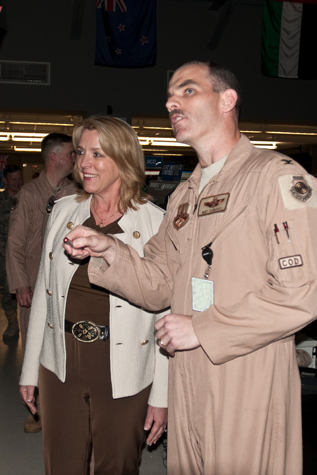 Col. Mike Schnabel, combat operations division director, gives Secretary of the Air Force Deborah Lee James a tour of the Combined Air and Space Operations Center (CAOC) at Al Udeid Air Base, Qatar, March 18, 2014. Serving as the operational bridge that integrates and synchronizes strategic decisions to tactical level execution, the CAOC provides the command and control of airpower throughout Afghanistan and several other nations. (U.S. Air Force photo/Staff Sgt. Benjamin Mota)