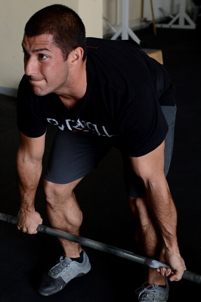 U.S. Air Force Senior Airman Anthony Pelaez, 52nd Component Maintenance Squadron jet engine mechanic from Miami, performs a dead lift during a combat Airmen fitness workout at Spangdahlem Air Base, Germany, March 14, 2014. Combat Airmen fitness is a sport that revolves around high-intensity interval training. (U.S. Air Force photo by Airman 1st Class Kyle Gese/Released)