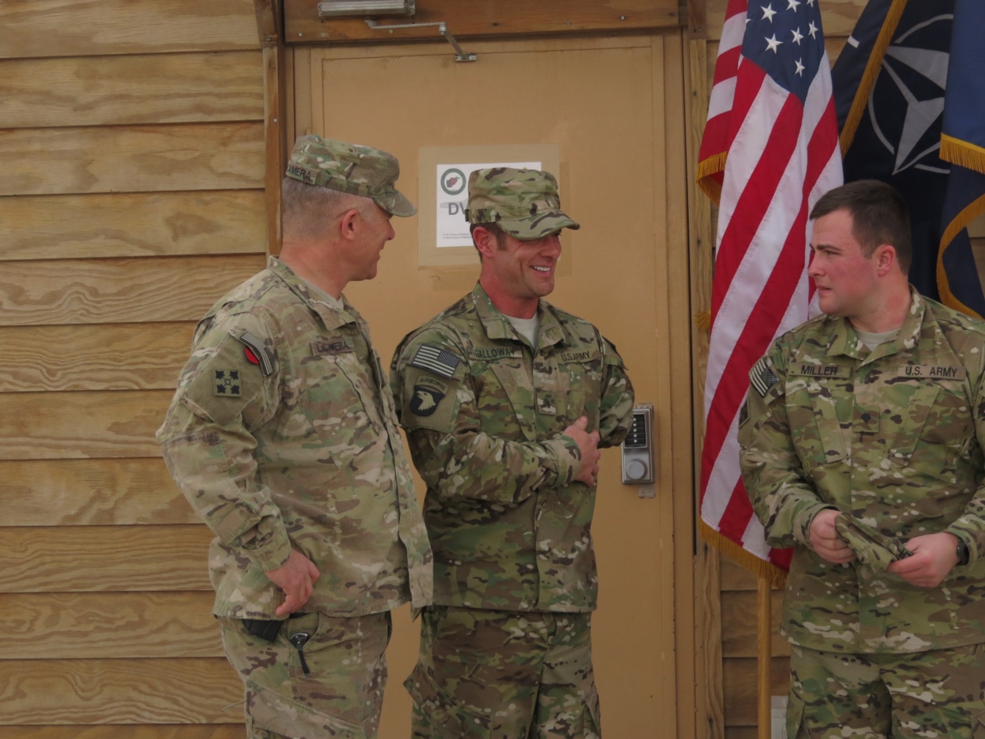 U.S. Army Maj. Gen. Paul LaCamera, commanding general, 4th Infantry Division, Fort Carson, Colo., stands proudly with retired Sgt. Noah Galloway and retired Spc. Andrew Miller as the men arrive for the fifth edition of Operation Proper Exit at Kandahar Airfield, Afghanistan, March 13, 2014. Both soldiers have lost limbs on the battlefield. Galloway is a double amputee from injuries endured in the line of duty. He now serves as a personal trainer and has completed over 15 physically demanding races and marathons. (U.S. Air Force photo by Senior Airman Alexandria Bandin/Released)