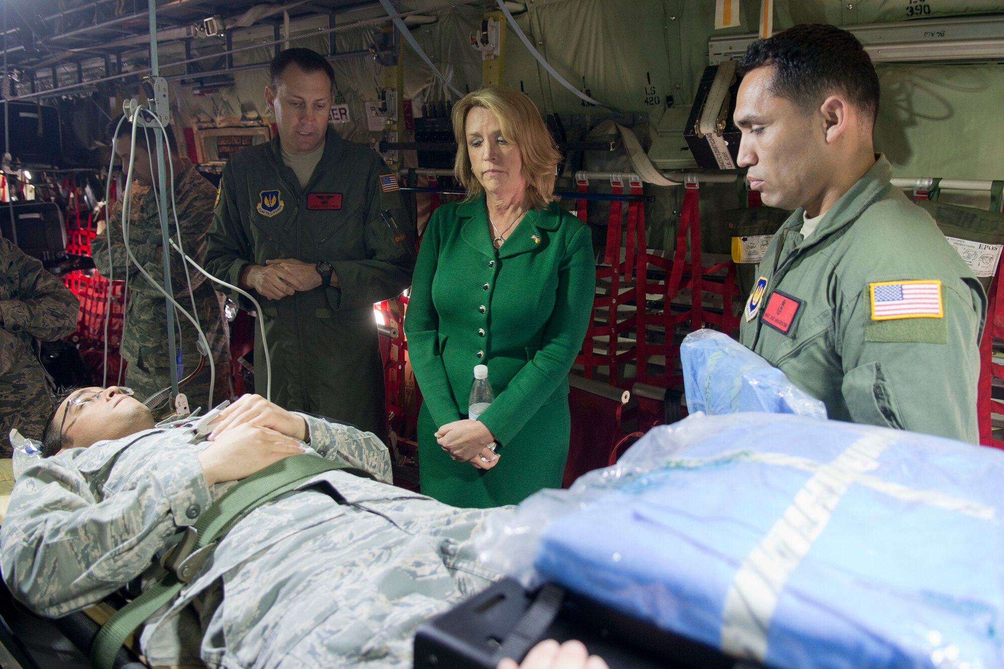 (Center) Secretary of the Air Force Deborah Lee James, during a visit March 17, 2014 to Ramstein Air Base, Germany, discusses with Lt. Col. Gerald Fortuna (left), 86th Medical Squadron trauma surgeon, how it is possible for surgeries to be performed in flight on a C-130J Super Hercules. During James' first visit to Europe as SecAF, she visited with Airmen in their workplaces and received briefings on Ramstein’s many missions. (U.S. Air Force photo/Senior Airman Jose L. Leon)