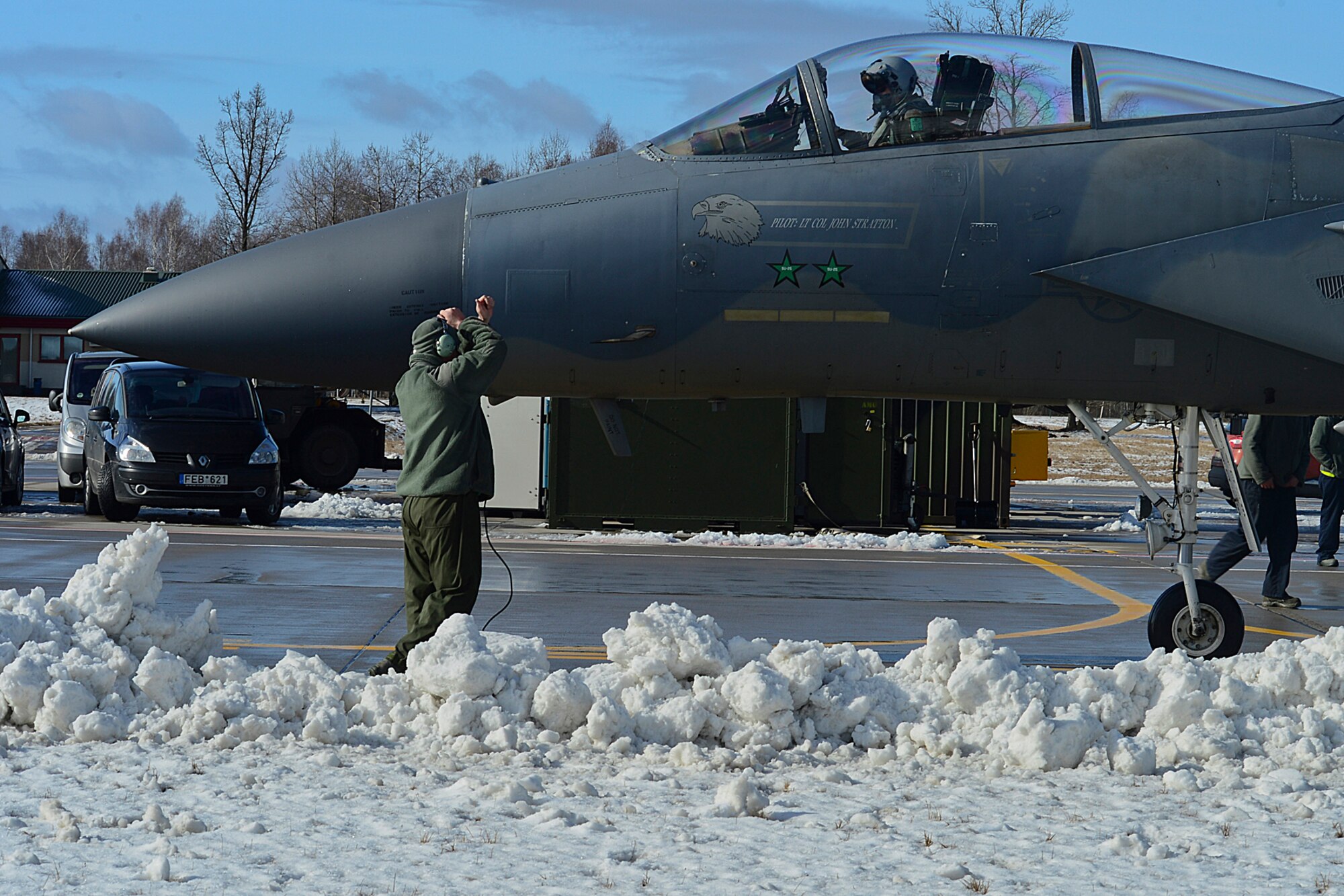 A 48th Air Expeditionary Group crew chief marshals an F-15C Eagle at Šiauliai Air Base, Lithuania, March 18, 2014.The 493rd Expeditionary Fighter Squadron regularly flies training missions while deployed to maintain readiness and proficiency. The U.S. Air Force F-15C Eagles' participation in the NATO Baltic Air Policing mission helps ensure a safe and stable future for the Baltics while preserving the integrity of NATO's borders and NATO security. (U.S. Air Force photo by Airman 1st Class Dana J. Butler)  