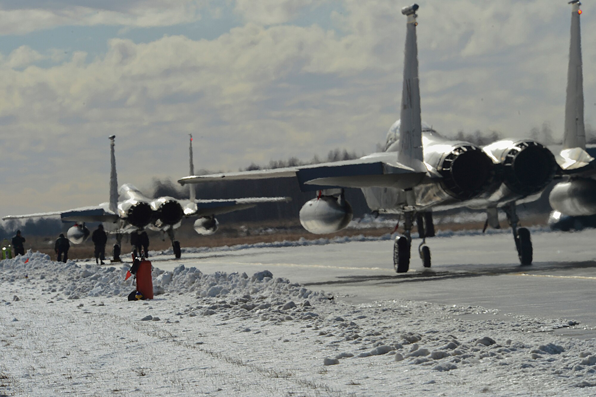 Two F-15C Eagles taxi to the runway at Šiauliai Air Base, Lithuania, March 18, 2014.The 493rd Expeditionary Fighter Squadron regularly flies training missions while deployed to maintain readiness and proficiency. The U.S. Air Force F-15C Eagles' participation in the NATO Baltic Air Policing mission helps ensure a safe and stable future for the Baltics while preserving the integrity of NATO's borders and NATO security. (U.S. Air Force photo by Airman 1st Class Dana J. Butler)  