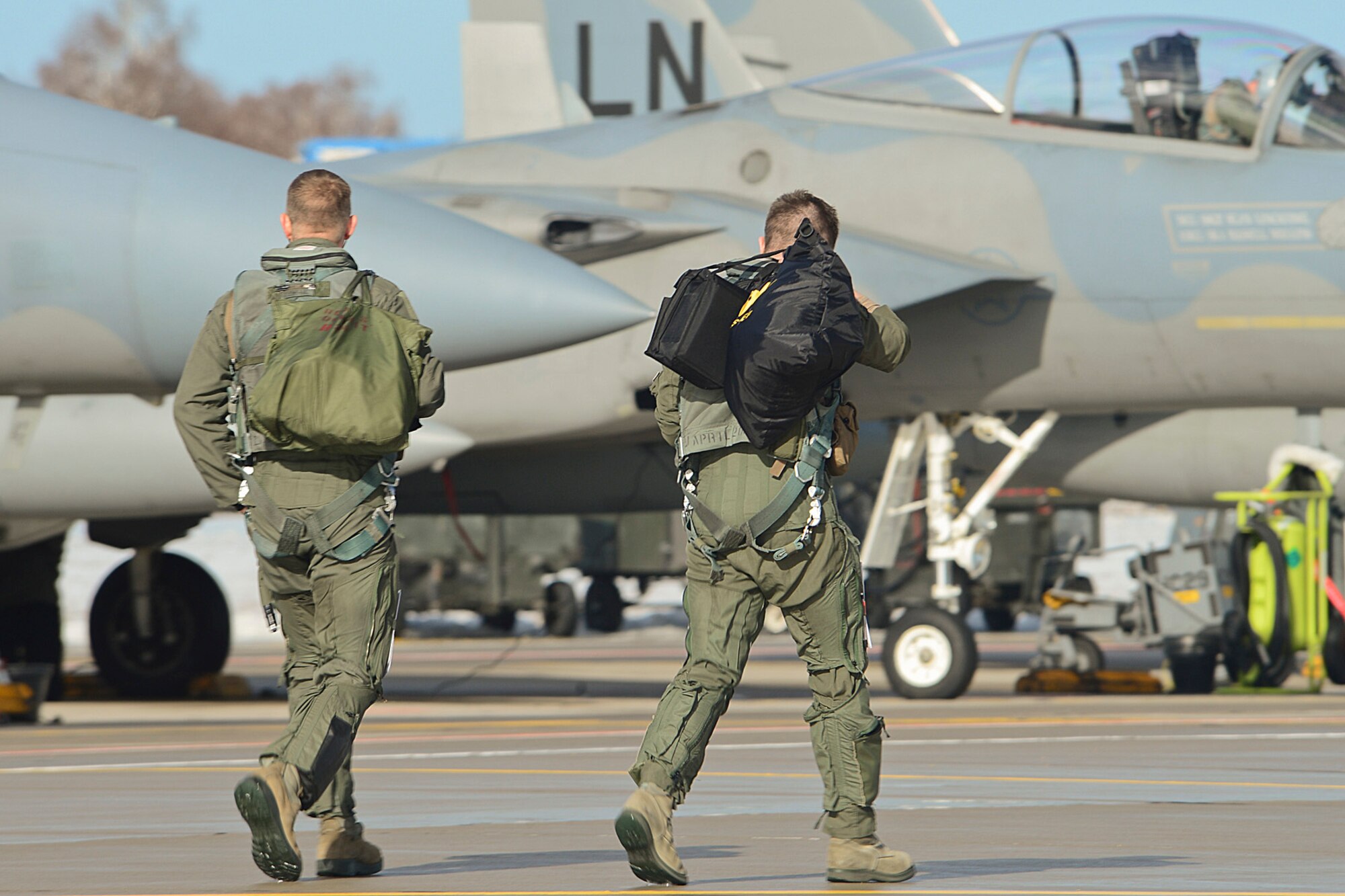 Maj. Barak Amundson and Capt. Tyler Clark, 493rd Expeditionary Fighter Squadron pilots, walk to their aircraft at Šiauliai Air Base, Lithuania, March 18, 2014.The 493rd EFS regularly flies training missions while deployed to maintain readiness and proficiency. (The U.S. Air Force F-15C Eagles' participation in the NATO Baltic Air Policing mission helps ensure a safe and stable future for the Baltics while preserving the integrity of NATO's borders and NATO security. (U.S. Air Force photo by Airman 1st Class Dana J. Butler)  