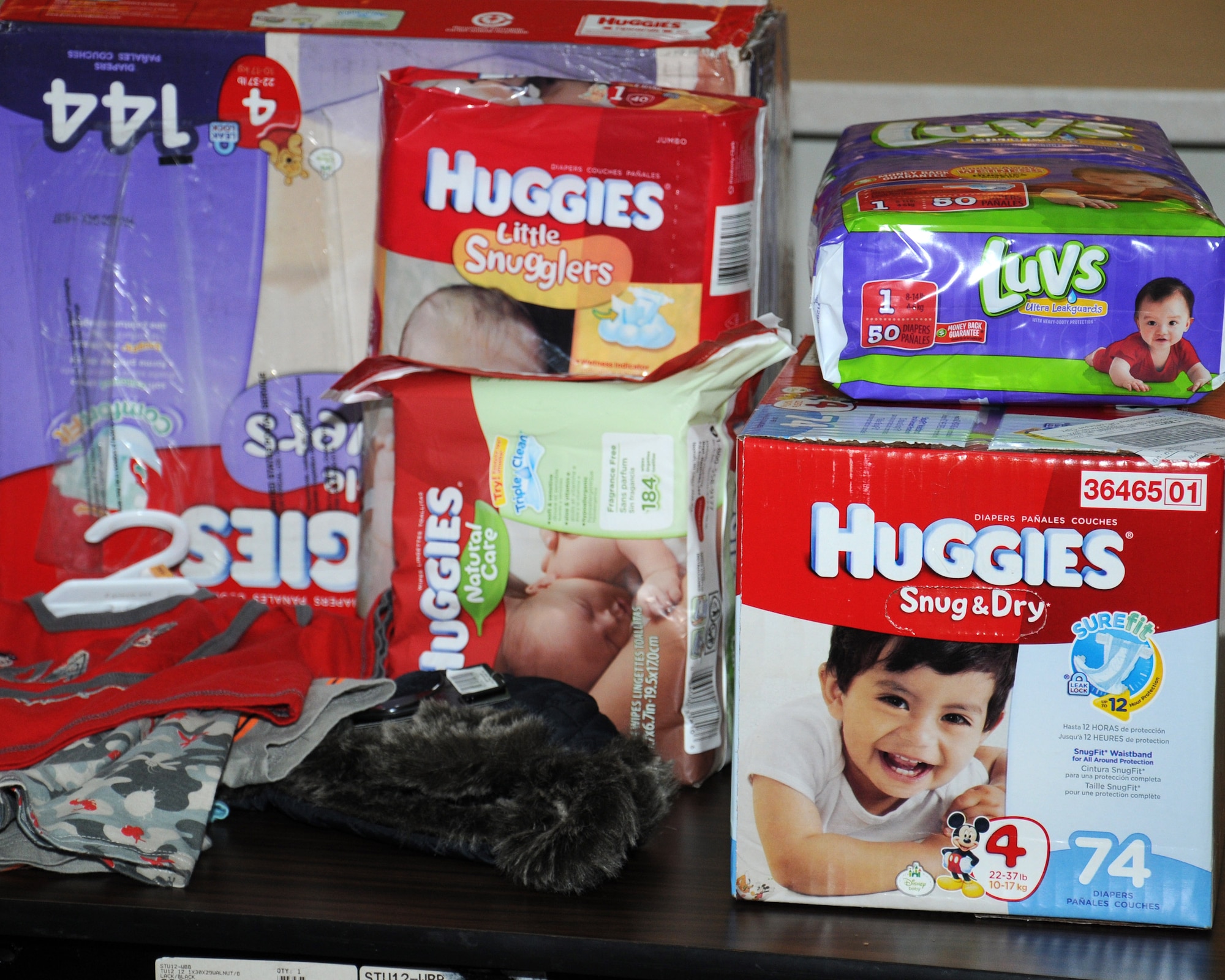 Diapers and clothing sit on display during a diaper drive March 14, 2014, in the chapel on RAF Mildenhall, England. Parents of children from the youth center and child development center donated diapers and clothing. (U.S. Air Force photo by Gina Randall/Released)