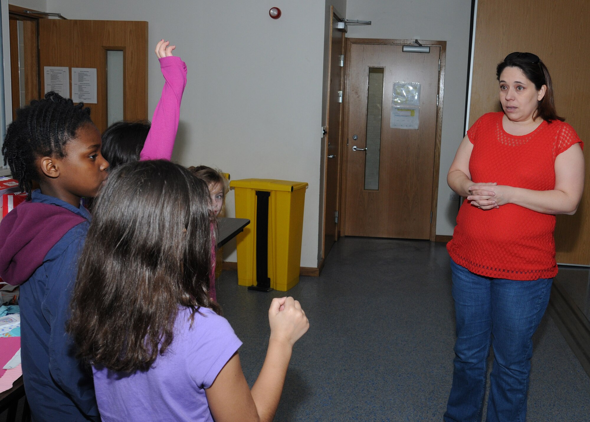 Misty Villarin, right, a member of the RAF Mildenhall enlisted spouses club, talks to children from the RAF Mildenhall Youth Center about where donated diapers will go during a diaper drive March 14, 2014, in the chapel on RAF Mildenhall, England. Parents of children from the youth center and child development center donated diapers and clothing. Children from the RAF Mildenhall Youth Center, with help from staff, collected the items for a month. (U.S. Air Force photo by Gina Randall/Released)