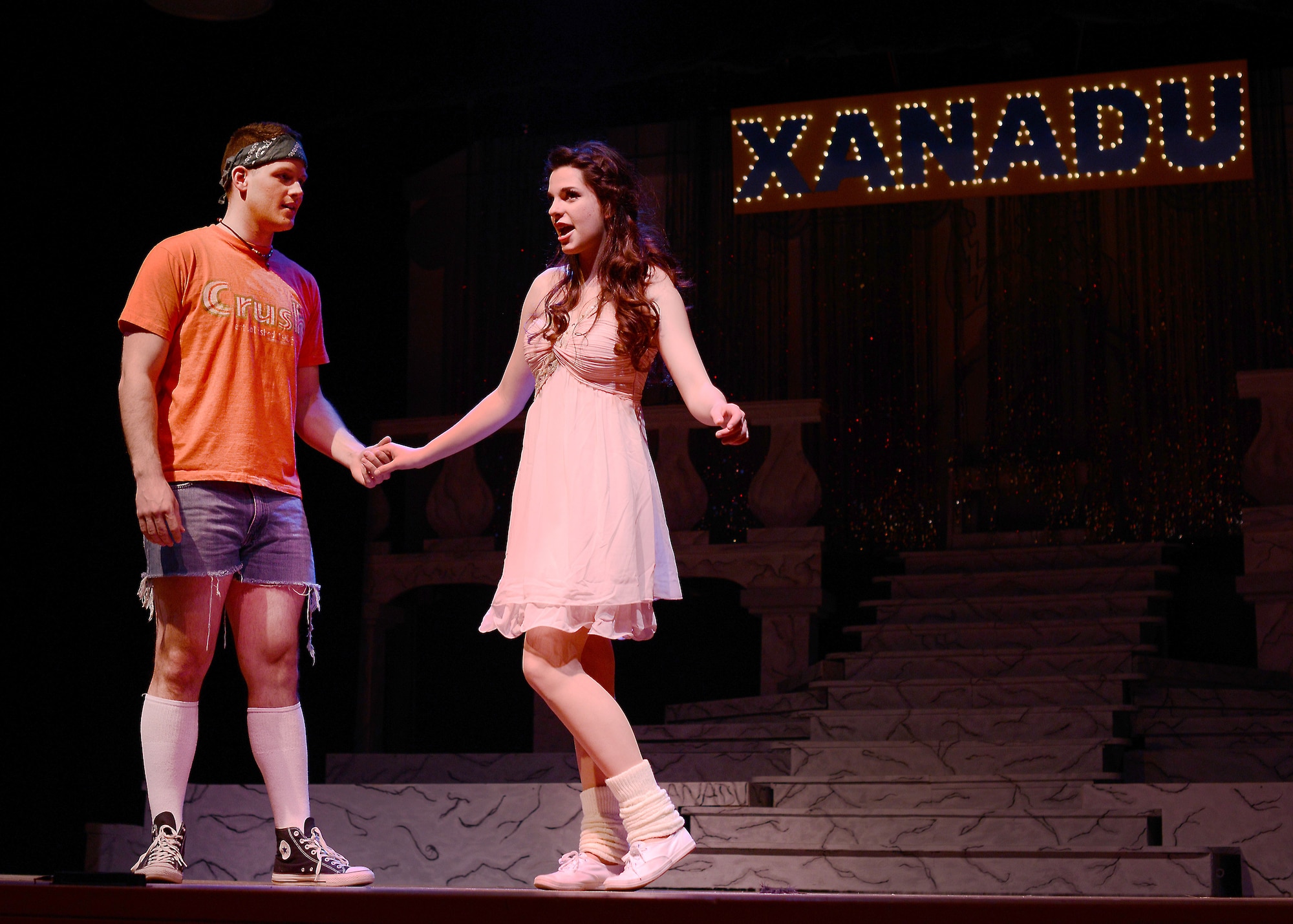 Airman 1st Class Joshua Blackburn, Detachment 8 American Forces Network broadcast journalist, and Annalisa Hardin, Aviano High School junior, perform a duet as Sonny Malone and Kira in the Aviano Community Theater performance, “Xanadu,” March 15, 2014, at Aviano Air Base, Italy.  The Aviano Community Theater cast included more than 50 Team Aviano members. (U.S. Air Force photo/Airman 1st Class Deana Heitzman)
