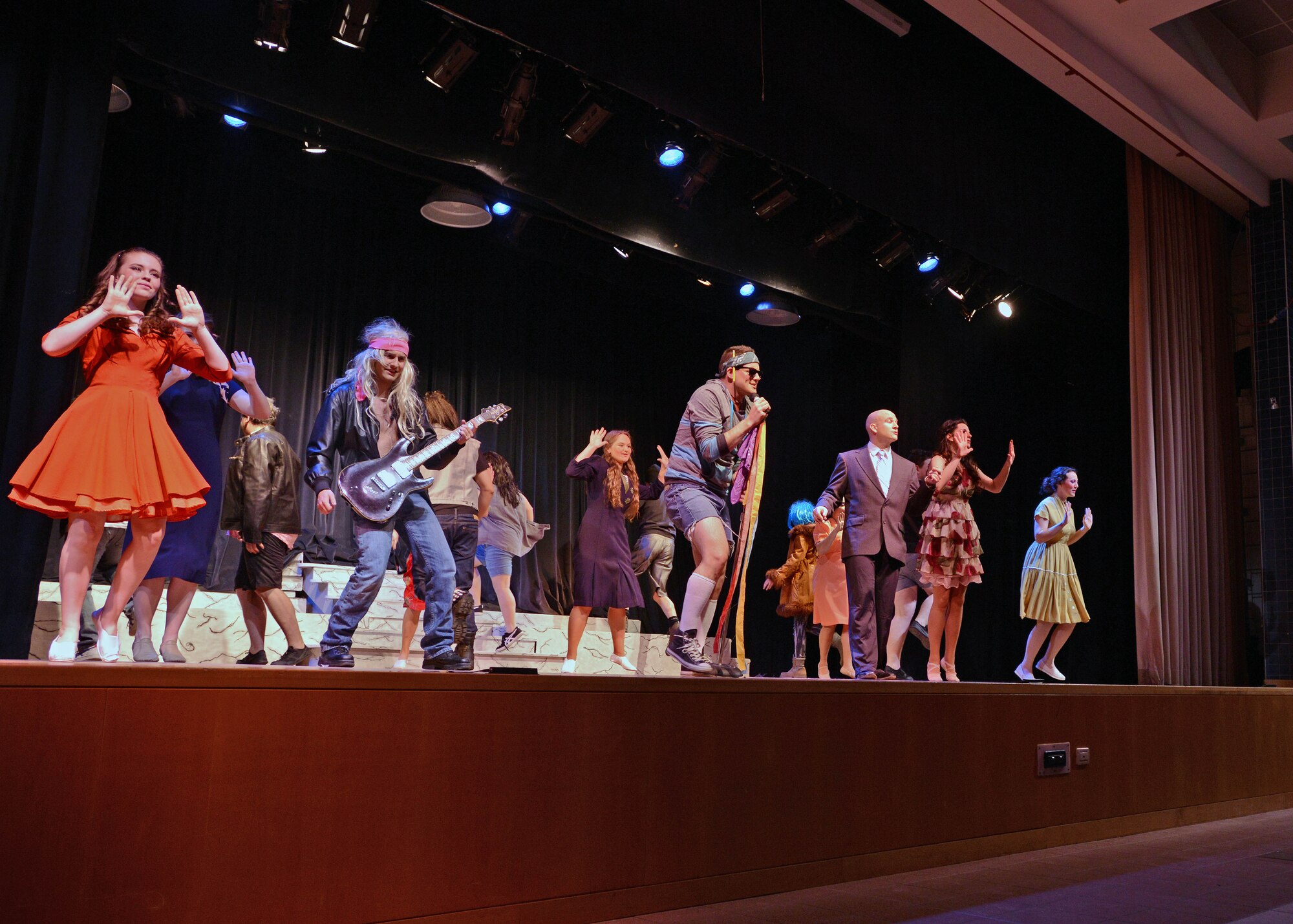 The cast of the Aviano Community Theater performance, “Xanadu,” dance during an act, March 15, 2014, at Aviano Air Base, Italy. “Xanadu” is an ‘80s love story between an uninspired artist and a Greek muse who helps him fulfill a lifelong dream of opening a roller disco. (U.S. Air Force photo/Airman 1st Class Deana Heitzman)  