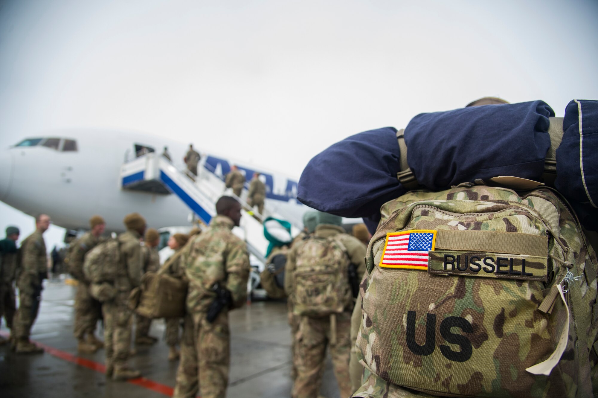 U.S. Soldiers board a plane at Transit Center at Manas, Kyrgyzstan, Feb. 21, 2014. U.S. and coalition members transited through the TCM on the last camber flight before the base closure. A camber flight is one that flies directly to a military installation. (U.S. Air Force photo/Senior Airman George Goslin)