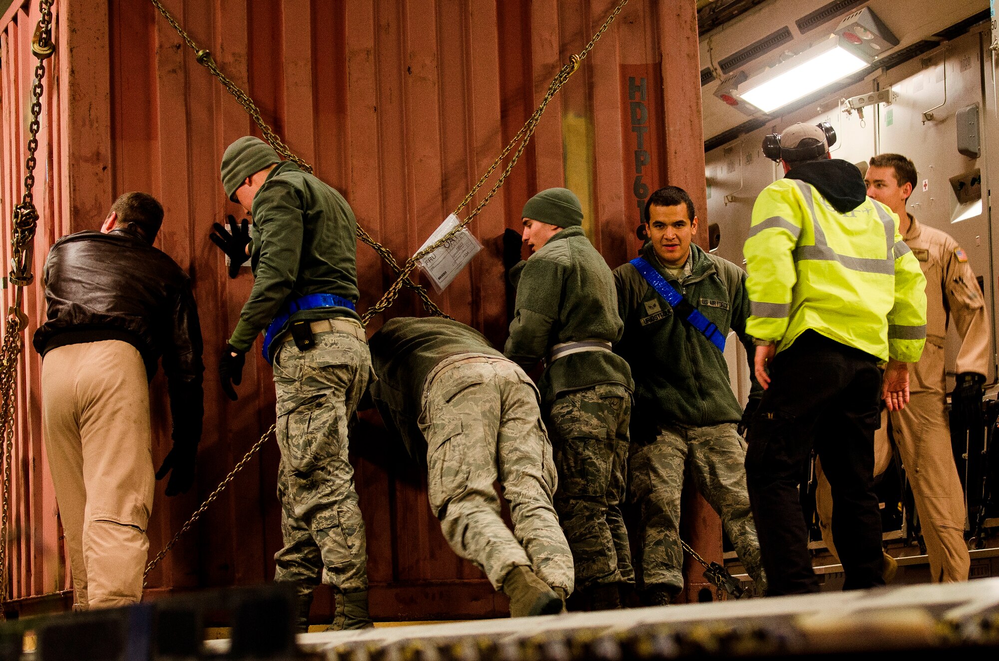 Airmen push cargo in place on a C-17 Globemaster III at the Transit Center at Manas, March 14, 2014. The C-17 is vital to cargo and equipment movement from the Transit Center. The transfer of equipment is in preparation for the Transit Center closure, scheduled for July 10, 2014. (U.S. Air Force photo/Senior Airman Ross Alexander Whitley)