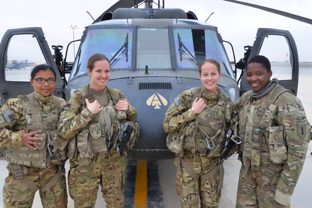 From left to right, U.S. Army Pfc. Ajia Gumabon, U.S. Army Chief Warrant Officer 2 Jessie Freeman, U.S. Army Capt. Katherine Wempe and U.S. Army Sgt. Natasha Elusme pose for a photograph following a mission over Kandahar province, Afghanistan, March 12, 2014. 