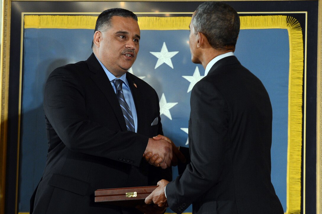 Richard Conde accepts the Medal of Honor on behalf of his late father, Army Sgt. 1st Class Felix M. Conde-Falcon, from President Barack Obama during a ceremony at the White House, March 18, 2014. Conde-Falcon, then a staff sergeant, distinguished himself by acts of gallantry and intrepidity above and beyond the call of duty while serving as an acting platoon leader assigned to the 82nd Airborne Division's Company D, 1st Battalion, 505th Infantry Regiment, 3rd Brigade, during combat operations against an armed enemy in Ap Tan Hoa, Vietnam, April 4, 1969.