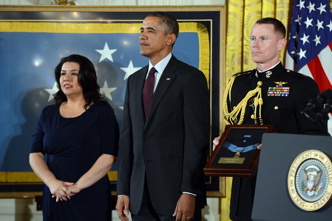 Tina Duran-Ruvalcaba accepts the Medal of Honor on behalf of her late father, Army Spec. 4 Jesus S. Duran, from President Barack Obama during a ceremony at the White House, March 18, 2014. Duran distinguished himself by acts of gallantry and intrepidity above and beyond the call of duty while serving as an acting M-60 machine gunner assigned to the 1st Cavalry Division's Company E, 2nd Battalion, 5th Cavalry Regiment, during combat operations against an armed enemy in Vietnam, April 10, 1969.