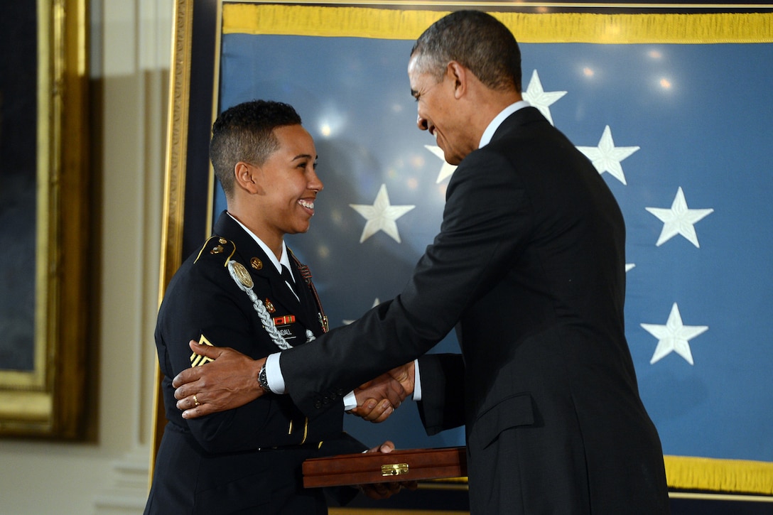 Army Sgt. Ashley Randall accepts the Medal of Honor on behalf of her late grandfather, Army Pvt. Demensio Rivera, from President Barack Obama during a ceremony at the White House, March 18, 2014. Rivera distinguished himself by acts of gallantry and intrepidity above and beyond the call of duty while serving as an automatic rifleman assigned to the 3rd Infantry Division's 2nd Platoon, Company G, 7th Infantry Regiment, during combat operations against an armed enemy in Changyong-ni, Korea, May 23, 1951.