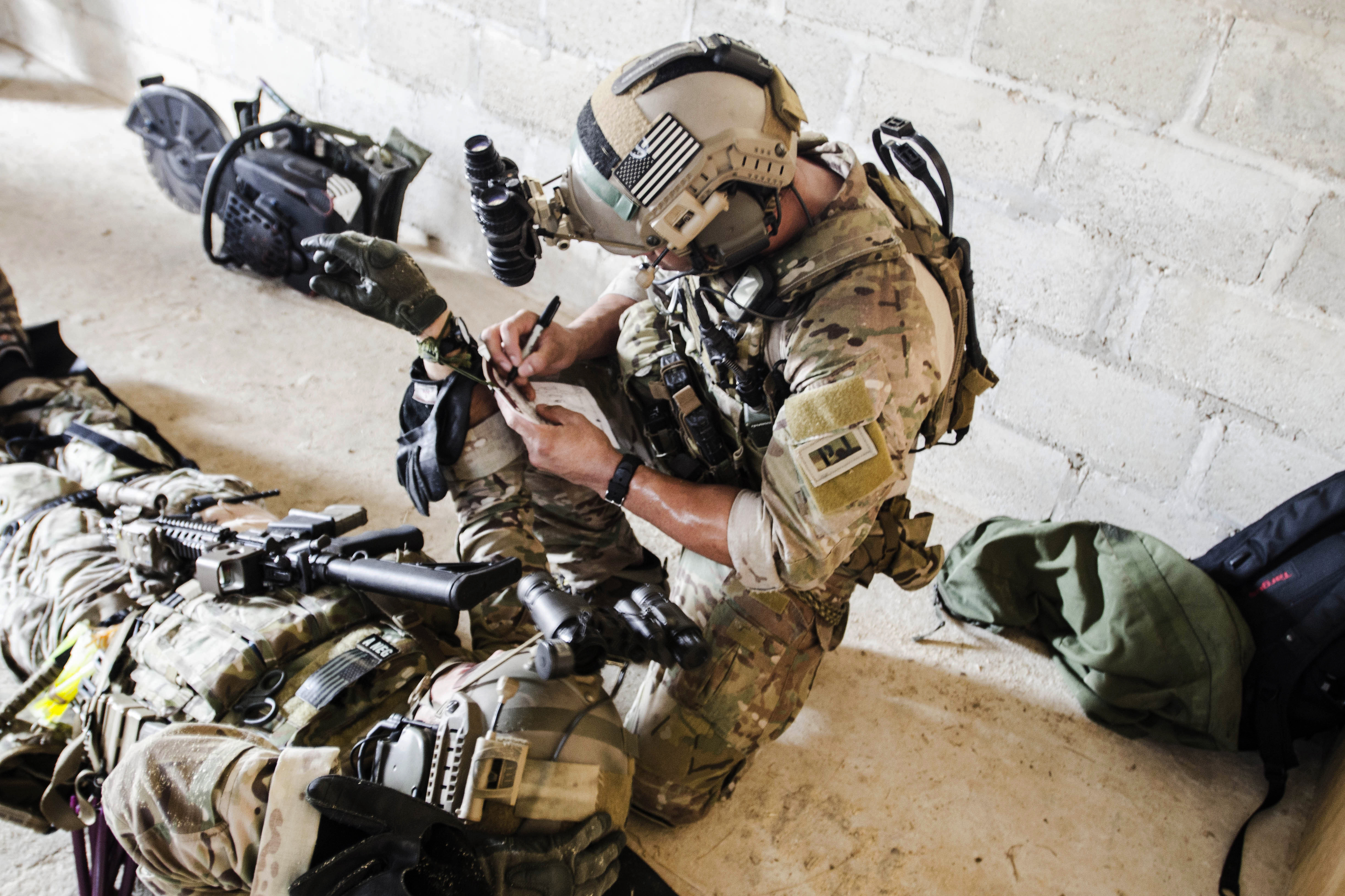 A U.S. Special Forces soldier provides medical aid to a member wounded