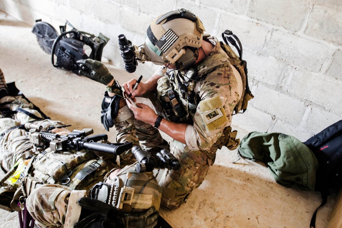 A U.S. Special Forces soldier provides medical aid to a member wounded while on a mission during Exercise Fused Response 2014 on Price Barracks in Belize City, Belize, March 13, 2014.