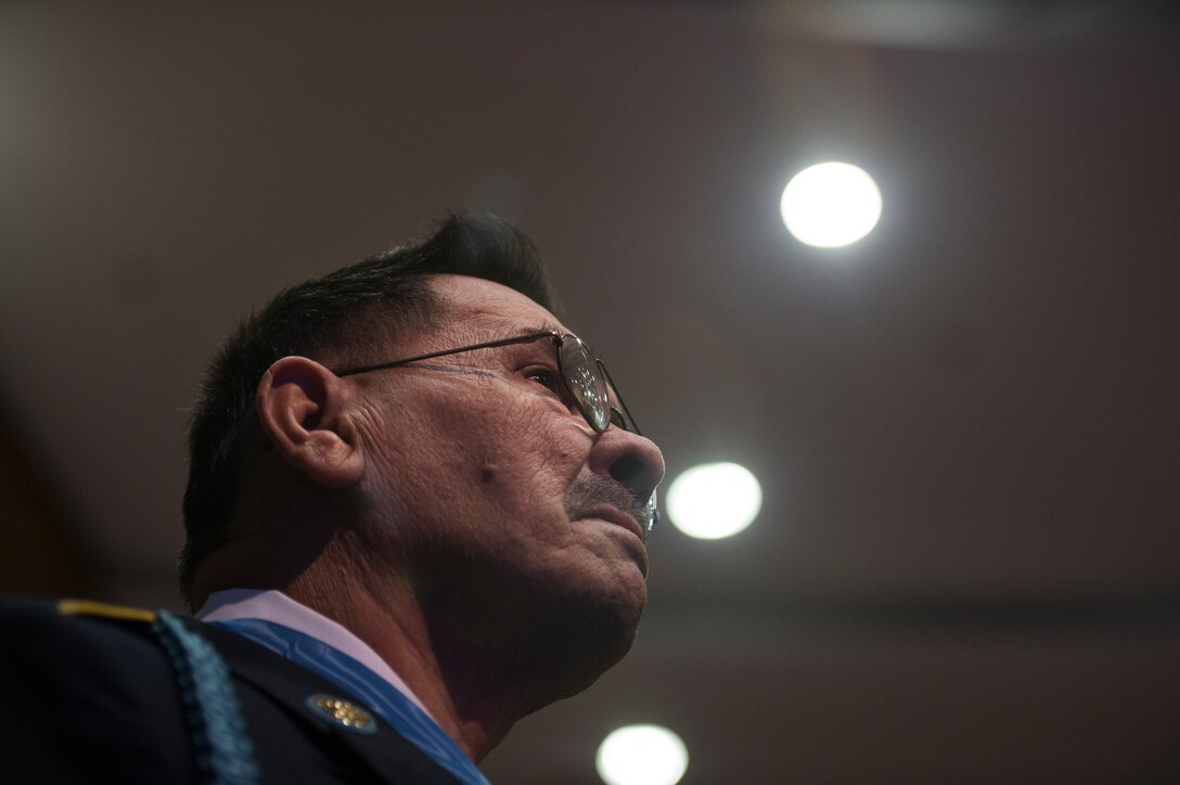 Army Sgt. Santiago J. Erevia stands to be recognized during a ceremony to induct him and 23 other Medal of Honor recipients into the Hall of Heroes at the Pentagon, March 19, 2014.  
