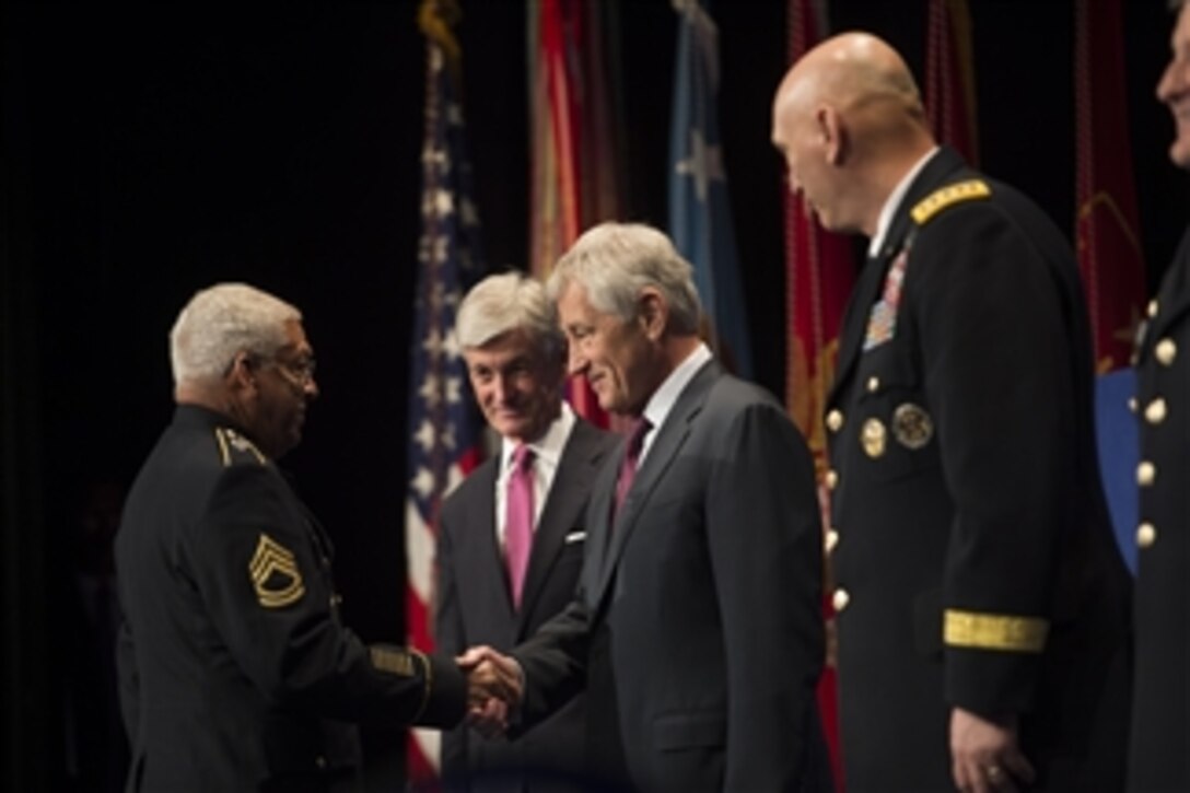 Defense Secretary Chuck Hagel shakes hands with Army Sgt. 1st Class Melvin Morris, one of 24 of the most recent Medal of Honor recipients, during a ceremony to induct all of them into the Hall of Heroes at the Pentagon, March 19, 2014. All recipients are Army veterans; only three are living. Army Secretary John M. McHugh and Army Chief of Staff Gen. Ray Odierno joined Hagel.